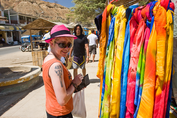 Sophie buying some colourful clothes in the market