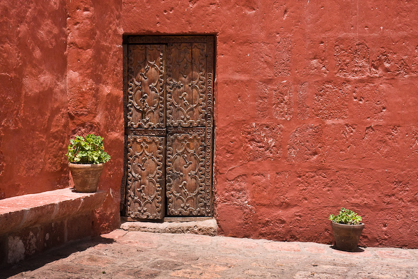Red walls with an old carved door
